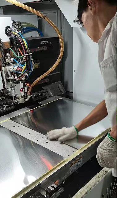 Technician working at PCB manufacturing equipment