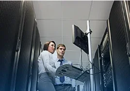 Technicians working between computer server racks.